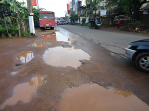 Status of road after newly laid asphalt. (Top left)No sidewalk. (Top right) Asphalt peeling off.