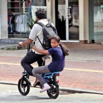 Bambalapitiya: Hitching a ride: A passenger hangs on perilously on a bicycle meant for one Pix by Indika Handuwala