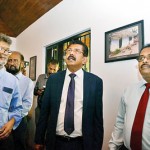 Environment Ministry Secretary Anil Jasinghe and others taking in the photographs at Sam Popham Museum