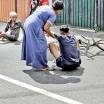 Mattakkuliya: Helping hand: A woman assists a fallen cyclist. Pic by M A Pushpa Kumara