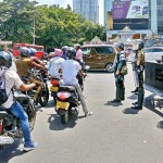 Borella: Life goes on: Armed Police stand ready for protesters in the city. Pic by Eshan Fernando